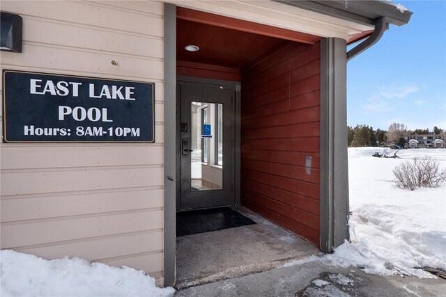 view of snow covered property entrance