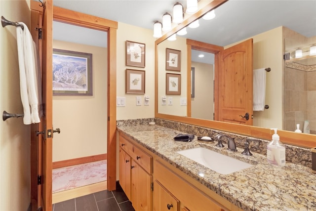 bathroom with tile patterned flooring, baseboards, and vanity