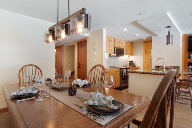 dining room featuring recessed lighting and light wood-style floors