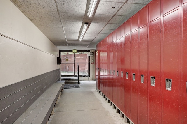 corridor with a paneled ceiling