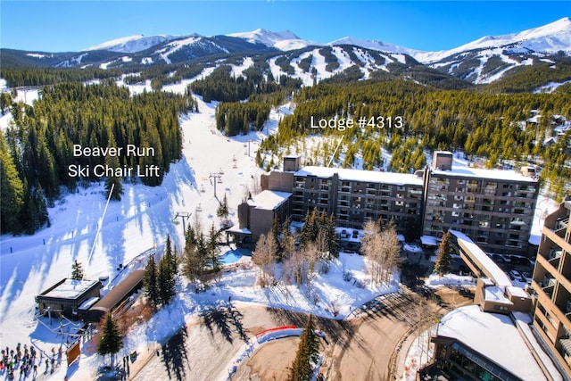 snowy aerial view with a mountain view