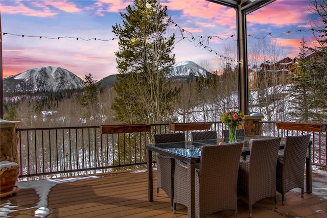 snow covered deck featuring a mountain view