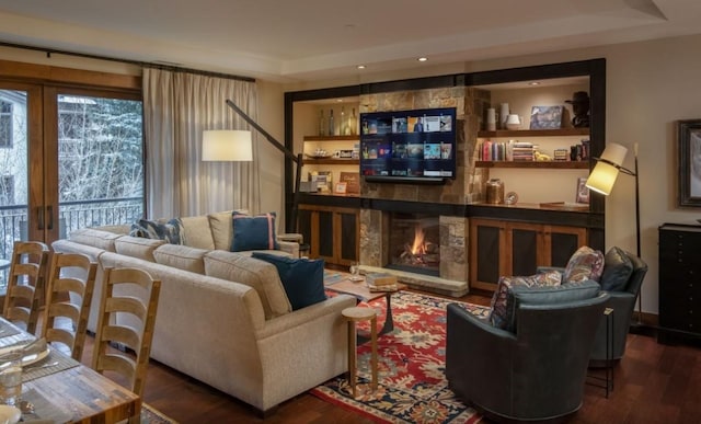 interior space featuring a fireplace, dark hardwood / wood-style flooring, and a tray ceiling