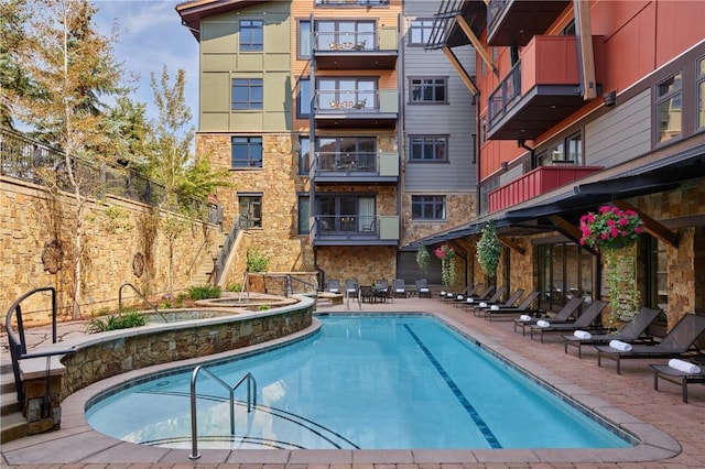 view of swimming pool with a community hot tub