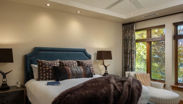 bedroom featuring ceiling fan and a tray ceiling