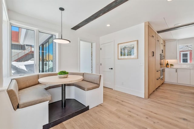 dining room featuring breakfast area, recessed lighting, light wood-style flooring, and baseboards