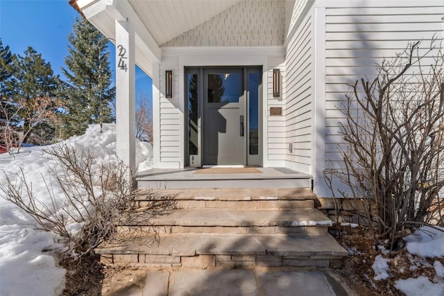 view of snow covered property entrance