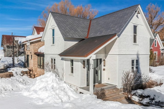 exterior space featuring a porch and a shingled roof