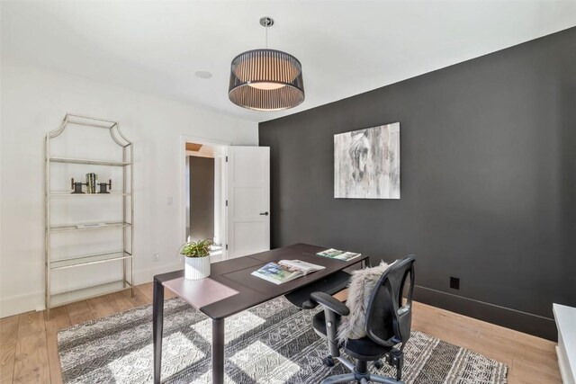 office with baseboards and light wood-style floors