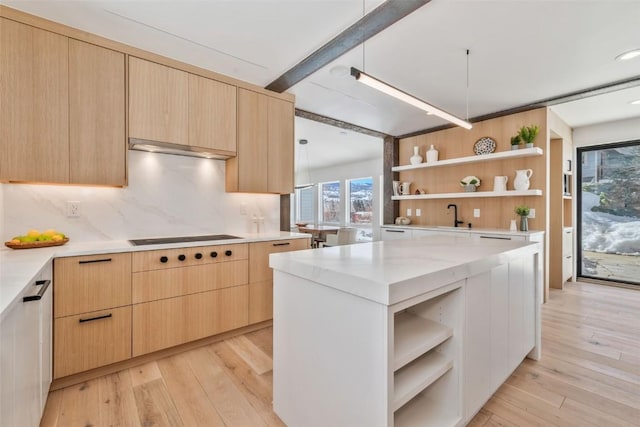 kitchen with electric cooktop, modern cabinets, light brown cabinets, and open shelves