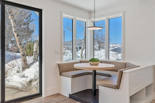 unfurnished dining area featuring breakfast area and wood finished floors