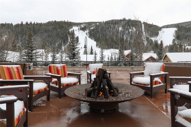 view of property's community featuring a mountain view, an outdoor living space, and a wooded view