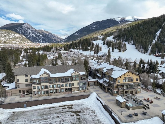 snowy aerial view with a mountain view