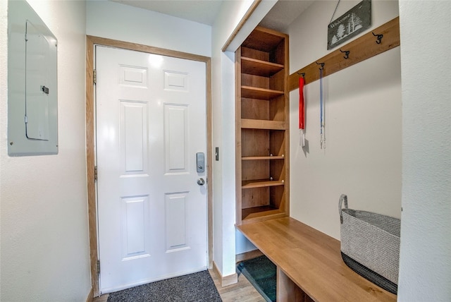 mudroom with electric panel and light hardwood / wood-style floors