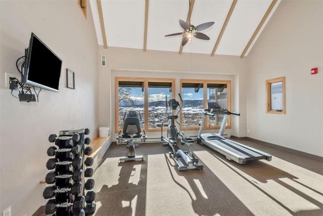 exercise room featuring baseboards, visible vents, high vaulted ceiling, and a ceiling fan