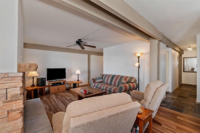 living room with a ceiling fan, dark wood finished floors, and beam ceiling