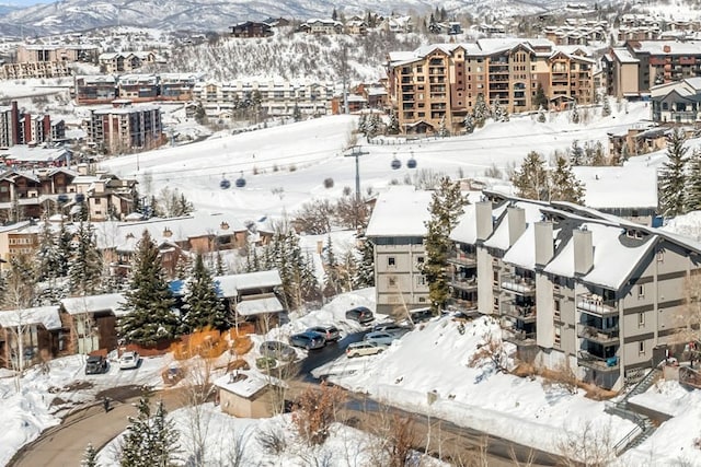 snowy aerial view featuring a mountain view