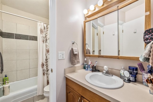 full bathroom with vanity, shower / tub combo, and toilet