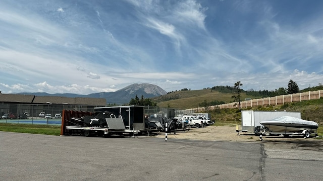 view of car parking with a mountain view and a carport