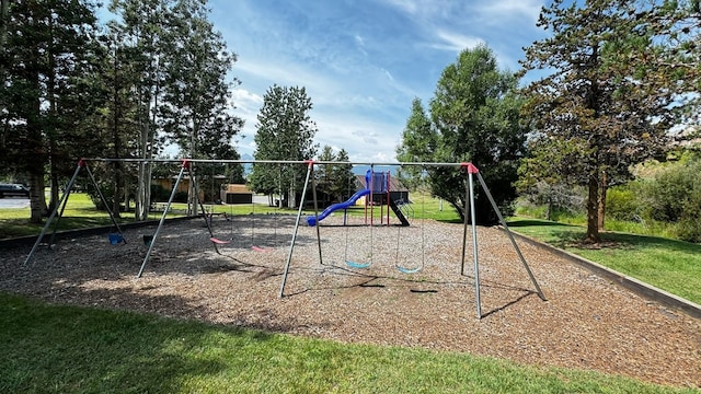 view of jungle gym featuring a lawn