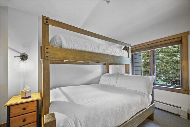 bedroom featuring dark carpet and a baseboard radiator