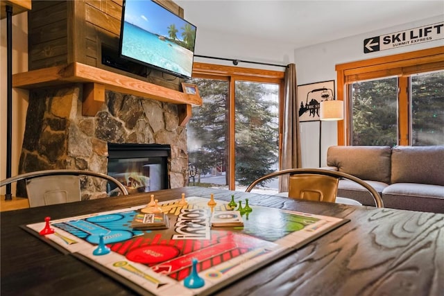 dining room featuring a stone fireplace