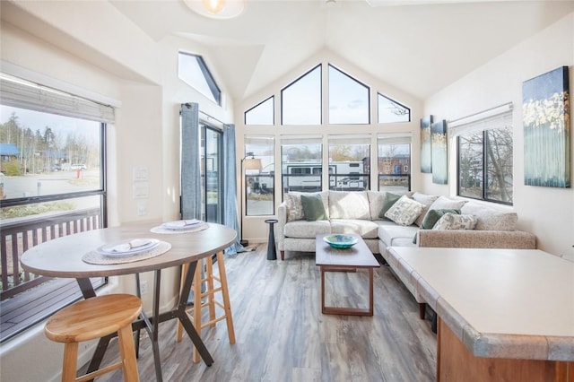 sunroom featuring plenty of natural light and vaulted ceiling