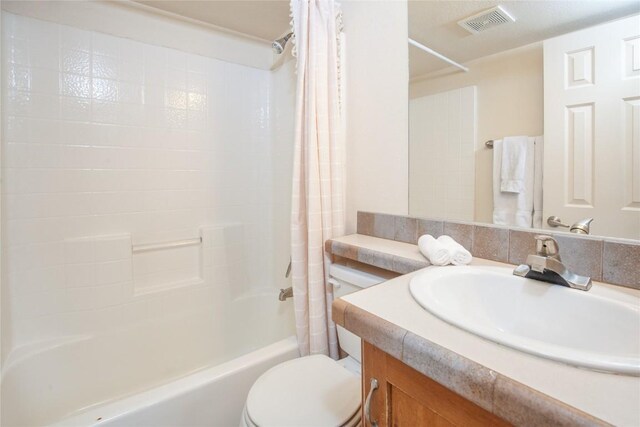 full bathroom featuring backsplash, shower / bathtub combination with curtain, vanity, and toilet