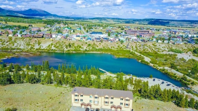 drone / aerial view featuring a water and mountain view