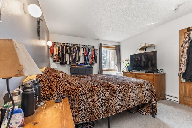 bedroom with carpet flooring, a textured ceiling, and a baseboard radiator