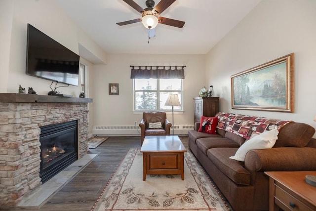 living room with a stone fireplace, dark hardwood / wood-style floors, ceiling fan, a baseboard radiator, and radiator heating unit