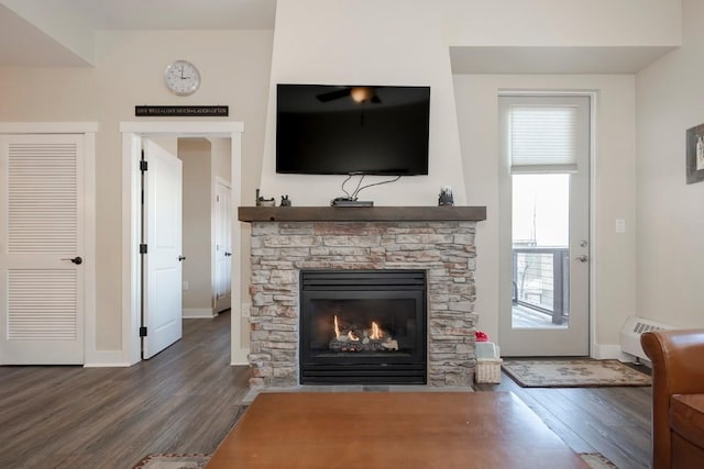 living room with dark hardwood / wood-style floors and a fireplace