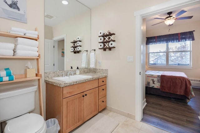 bathroom featuring tile patterned floors, radiator, vanity, ceiling fan, and toilet