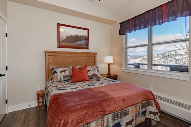 bedroom featuring radiator heating unit and dark hardwood / wood-style floors