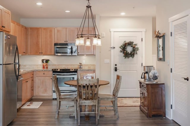 kitchen featuring light stone counters, light brown cabinets, decorative light fixtures, and appliances with stainless steel finishes