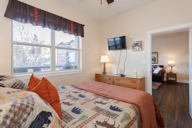 bedroom with ceiling fan and dark hardwood / wood-style floors