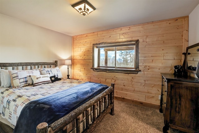 carpeted bedroom featuring wood walls