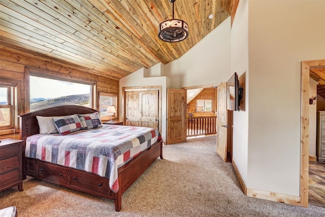 carpeted bedroom featuring high vaulted ceiling and wooden ceiling