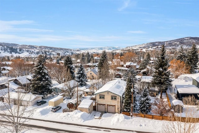 snowy aerial view with a mountain view