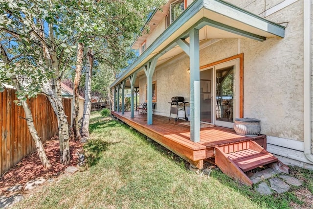 wooden deck with a grill and a yard