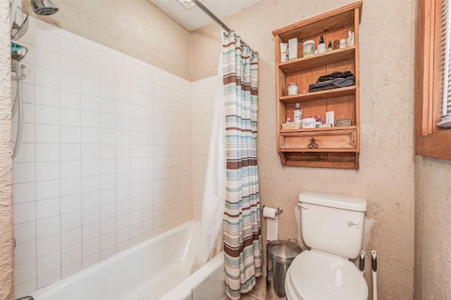 bathroom featuring shower / tub combo and toilet