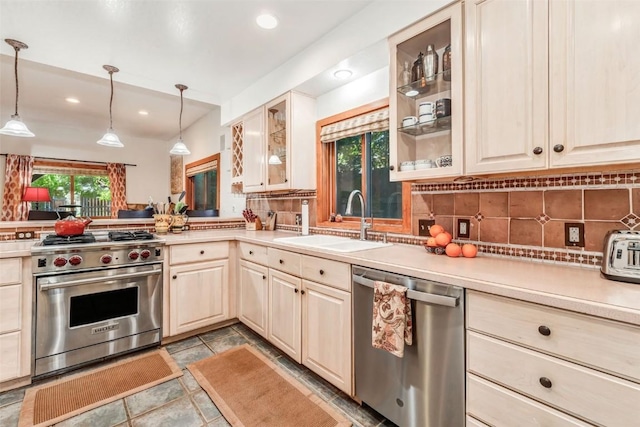 kitchen featuring tasteful backsplash, stainless steel appliances, sink, and pendant lighting