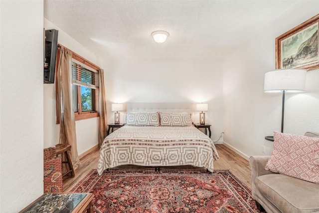 bedroom with light hardwood / wood-style flooring