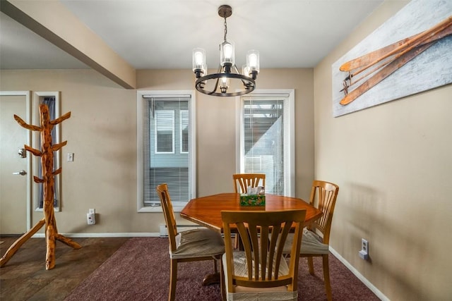 dining area featuring baseboards and a chandelier