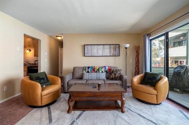 living room featuring light colored carpet and baseboards