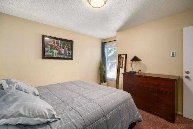 bedroom with baseboards, dark colored carpet, and a textured ceiling