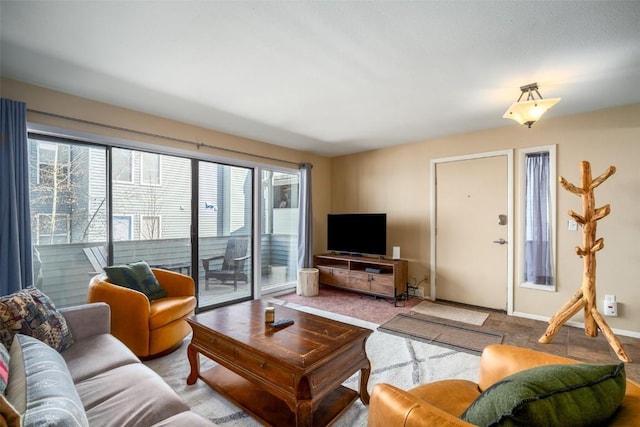 living area featuring baseboards