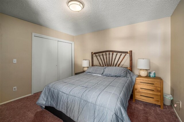 carpeted bedroom with a closet, a textured ceiling, and baseboards