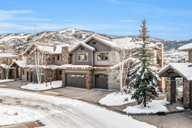 view of front of house with a garage and a mountain view