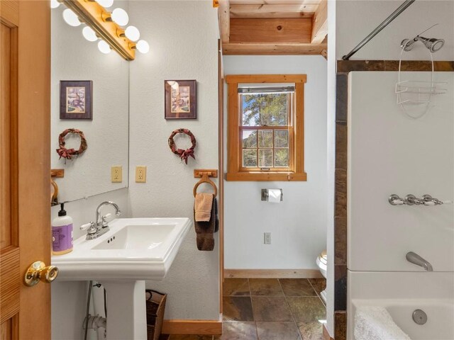 bathroom with shower / tub combination and toilet